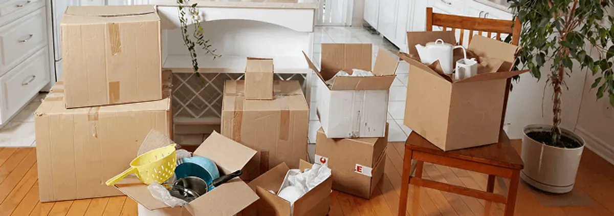Packed moving boxes and household items in a kitchen before move-out or move-in cleaning, Richmond, VA.